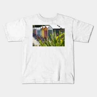 Boat sheds beyond the flax bushes. Kids T-Shirt